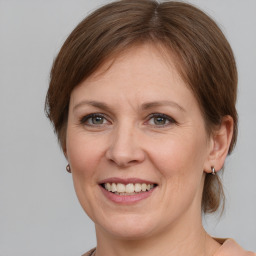 Joyful white adult female with medium  brown hair and grey eyes