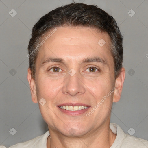 Joyful white adult male with short  brown hair and brown eyes