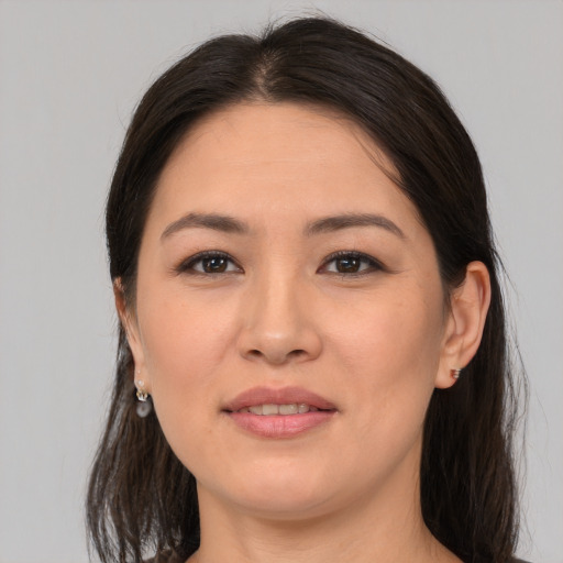 Joyful asian young-adult female with medium  brown hair and brown eyes