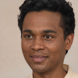 Joyful black young-adult male with short  black hair and brown eyes
