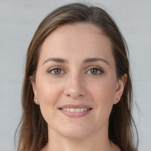 Joyful white young-adult female with long  brown hair and grey eyes