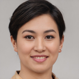 Joyful asian young-adult female with short  brown hair and brown eyes