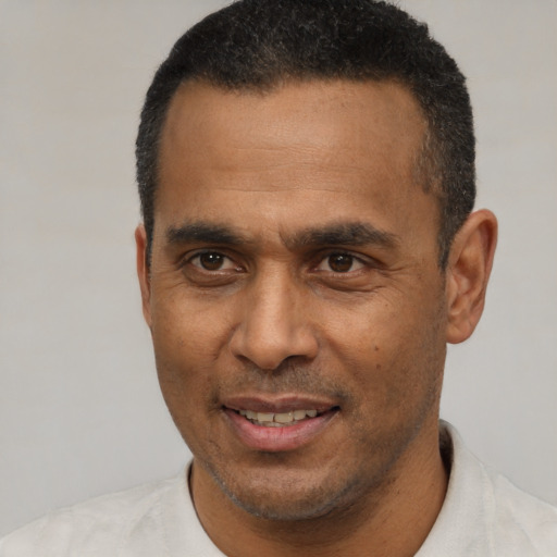 Joyful latino adult male with short  black hair and brown eyes