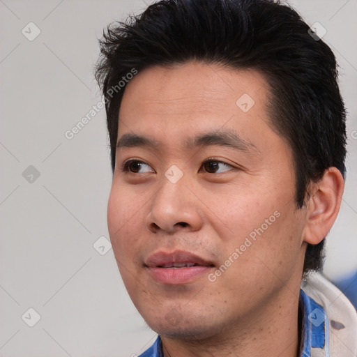 Joyful asian young-adult male with short  black hair and brown eyes