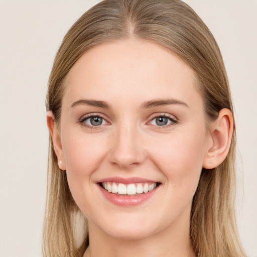 Joyful white young-adult female with long  brown hair and blue eyes