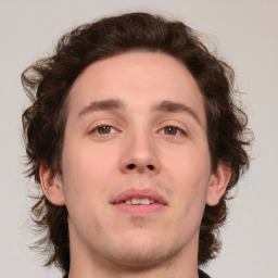 Joyful white young-adult male with medium  brown hair and brown eyes