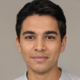 Joyful latino young-adult male with short  black hair and brown eyes