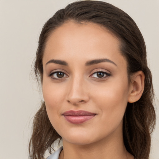 Joyful white young-adult female with long  brown hair and brown eyes