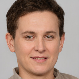 Joyful white adult male with short  brown hair and grey eyes