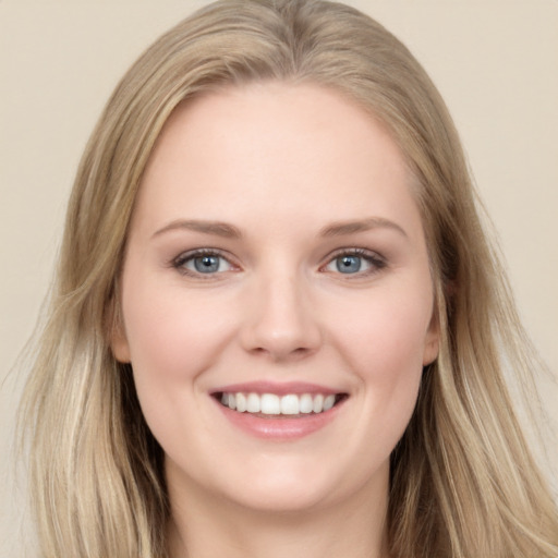 Joyful white young-adult female with long  brown hair and blue eyes