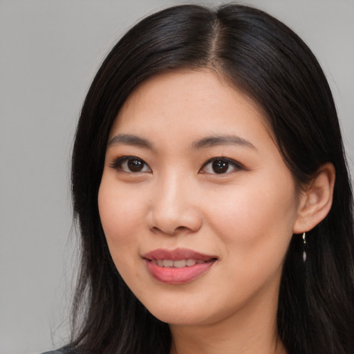 Joyful asian young-adult female with long  brown hair and brown eyes