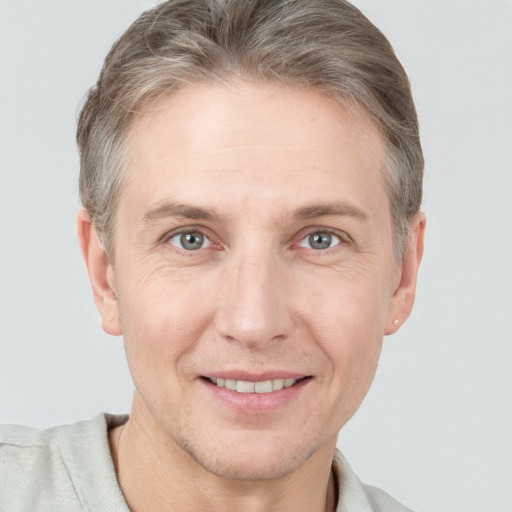 Joyful white adult male with short  brown hair and grey eyes