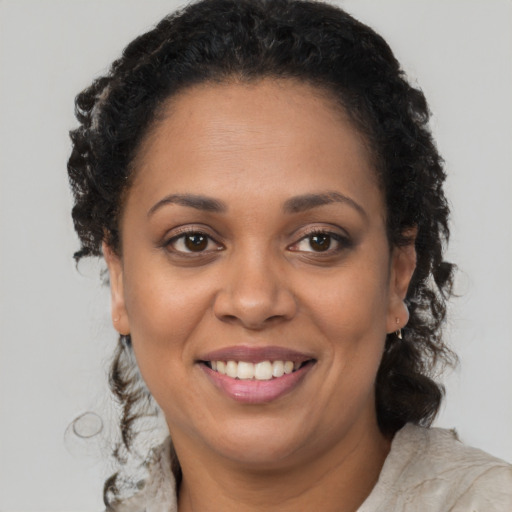 Joyful latino adult female with long  brown hair and brown eyes