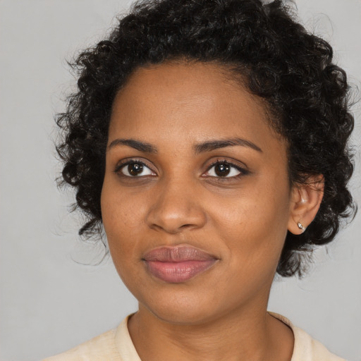 Joyful black young-adult female with medium  brown hair and brown eyes