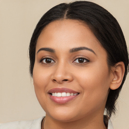 Joyful latino young-adult female with long  brown hair and brown eyes