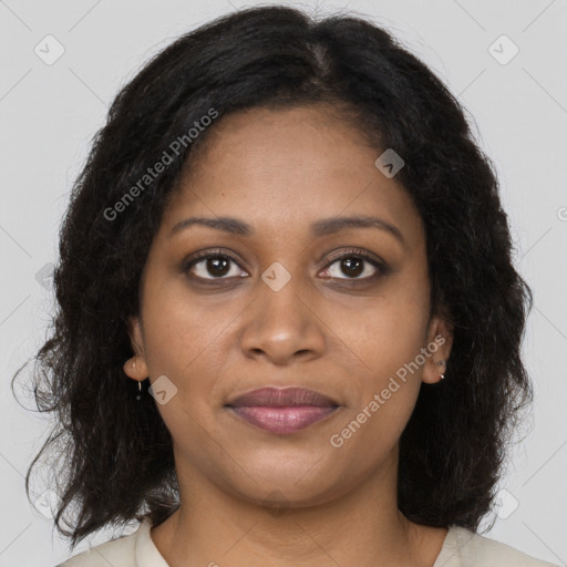 Joyful black young-adult female with long  brown hair and brown eyes