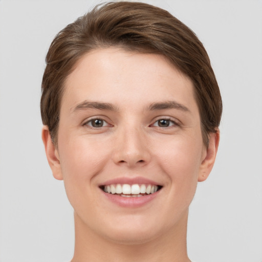 Joyful white young-adult female with short  brown hair and brown eyes