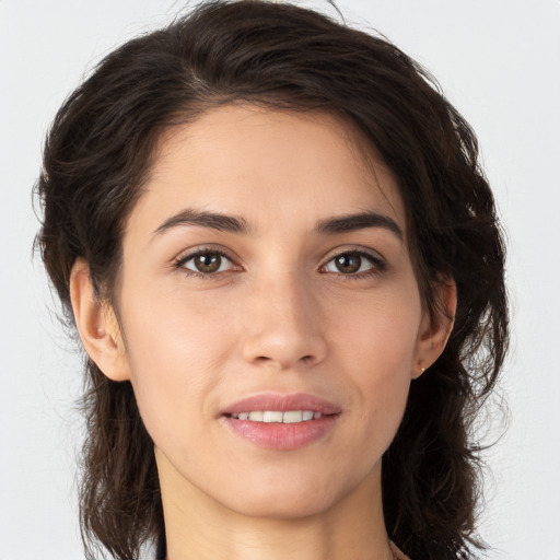 Joyful white young-adult female with long  brown hair and brown eyes