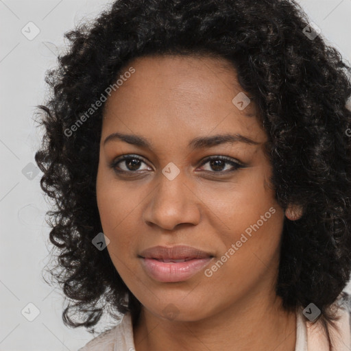 Joyful black young-adult female with long  brown hair and brown eyes