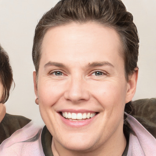 Joyful white young-adult female with short  brown hair and grey eyes