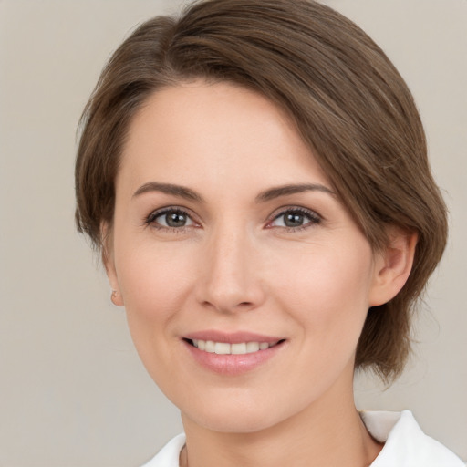 Joyful white young-adult female with medium  brown hair and brown eyes