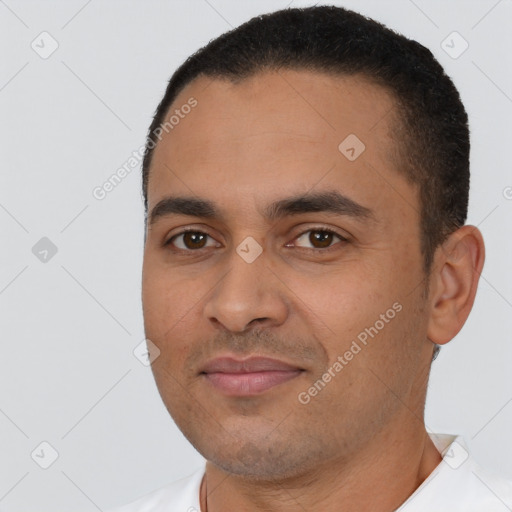 Joyful latino young-adult male with short  black hair and brown eyes