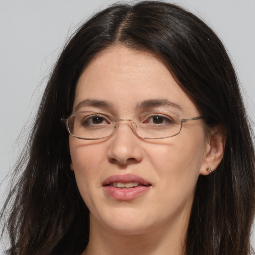 Joyful white adult female with long  brown hair and brown eyes