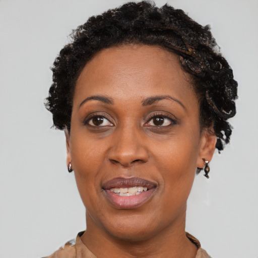 Joyful black adult female with short  black hair and brown eyes