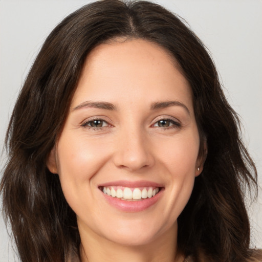 Joyful white young-adult female with long  brown hair and brown eyes