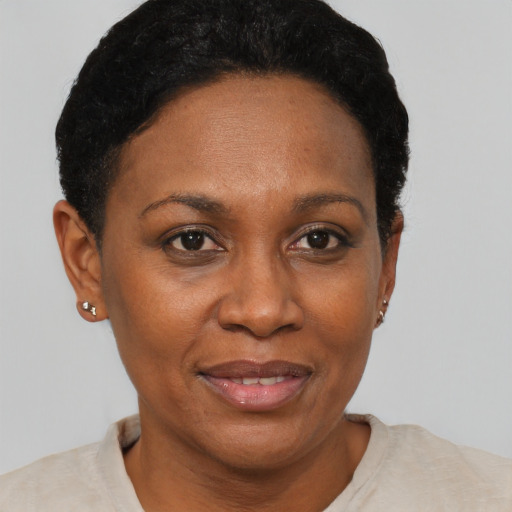 Joyful black adult female with short  brown hair and brown eyes