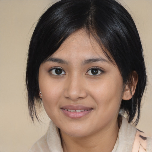 Joyful asian young-adult female with medium  brown hair and brown eyes