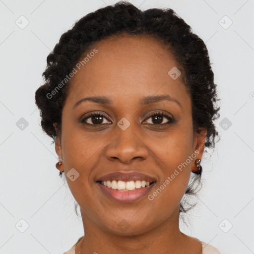 Joyful black young-adult female with long  brown hair and brown eyes