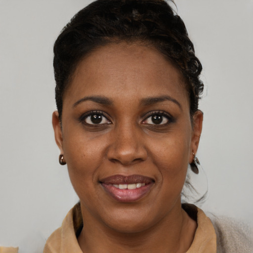 Joyful black young-adult female with short  brown hair and brown eyes