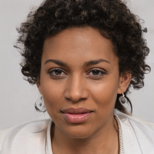 Joyful black young-adult female with medium  brown hair and brown eyes