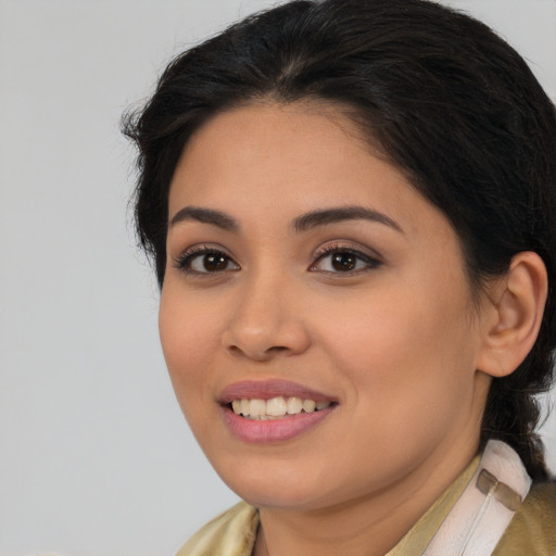 Joyful latino young-adult female with long  brown hair and brown eyes