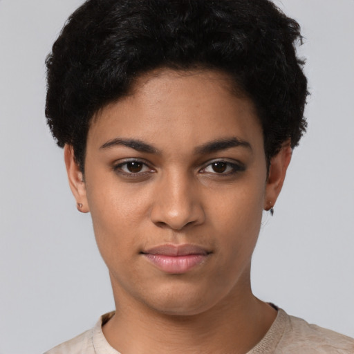 Joyful latino young-adult female with short  black hair and brown eyes