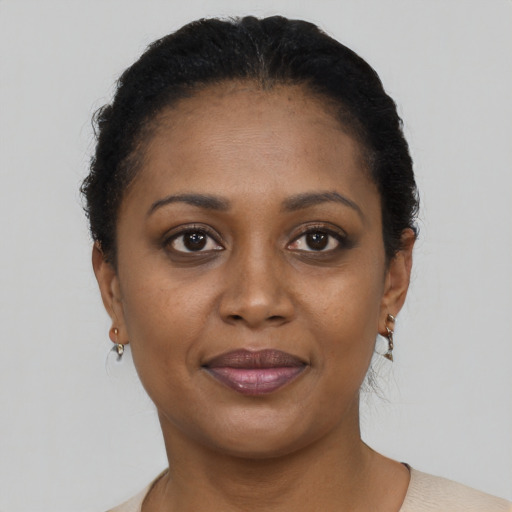 Joyful black young-adult female with short  brown hair and brown eyes