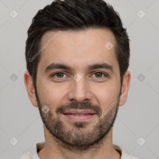 Joyful white young-adult male with short  black hair and brown eyes