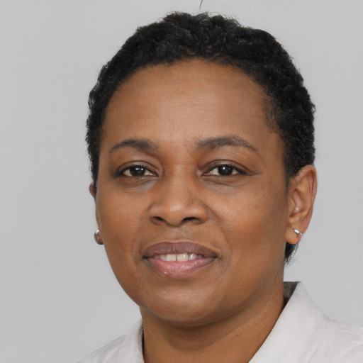 Joyful black adult female with short  black hair and brown eyes