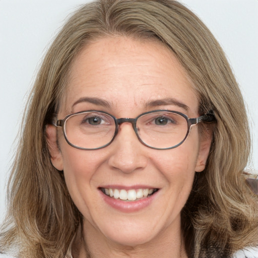 Joyful white adult female with medium  brown hair and brown eyes