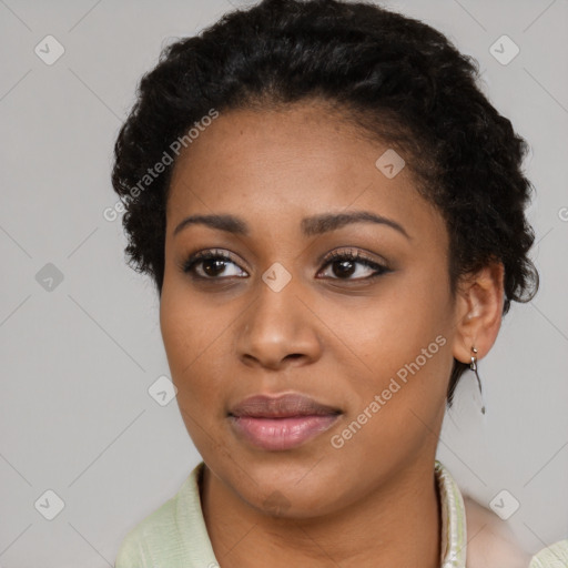 Joyful black young-adult female with short  brown hair and brown eyes