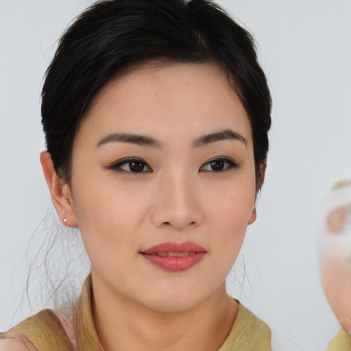 Joyful asian young-adult female with medium  brown hair and brown eyes