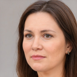 Joyful white adult female with long  brown hair and brown eyes