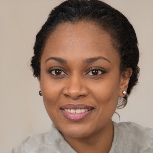 Joyful black young-adult female with medium  brown hair and brown eyes