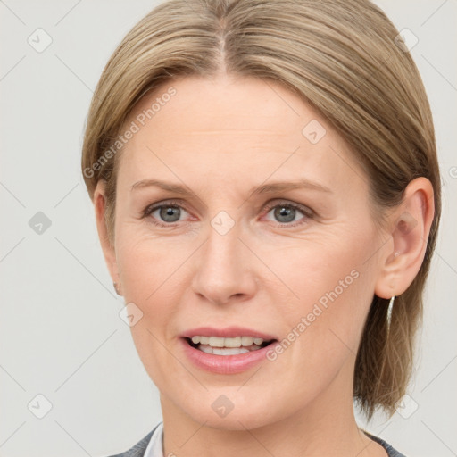 Joyful white adult female with medium  brown hair and blue eyes