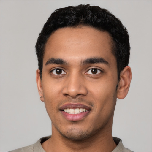 Joyful latino young-adult male with short  black hair and brown eyes