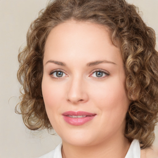 Joyful white young-adult female with medium  brown hair and green eyes