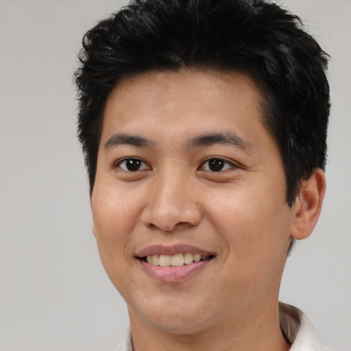 Joyful asian young-adult male with short  brown hair and brown eyes