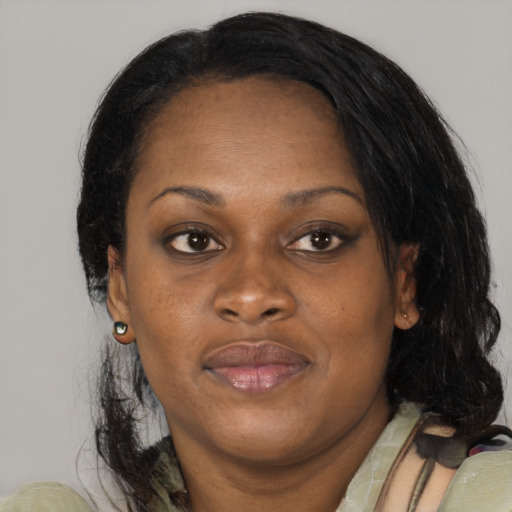 Joyful black adult female with medium  brown hair and brown eyes