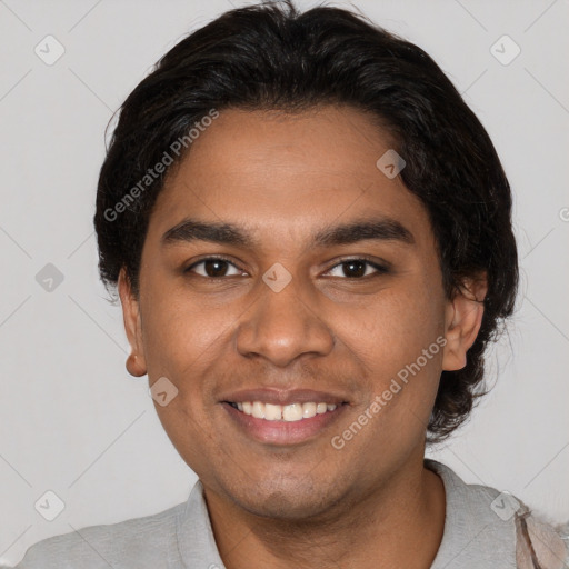 Joyful black young-adult male with short  brown hair and brown eyes